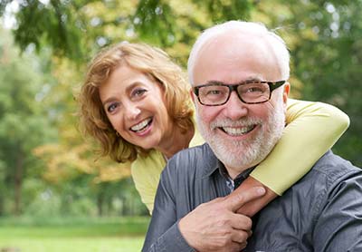 woman with her husband after a restorative dentistry appointment in Ashland, OH